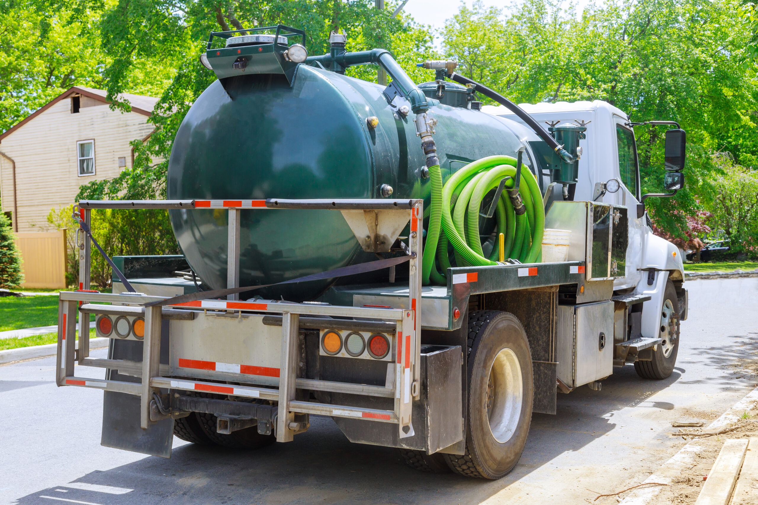 Green Septic Service Truck Parked on a Work Site
