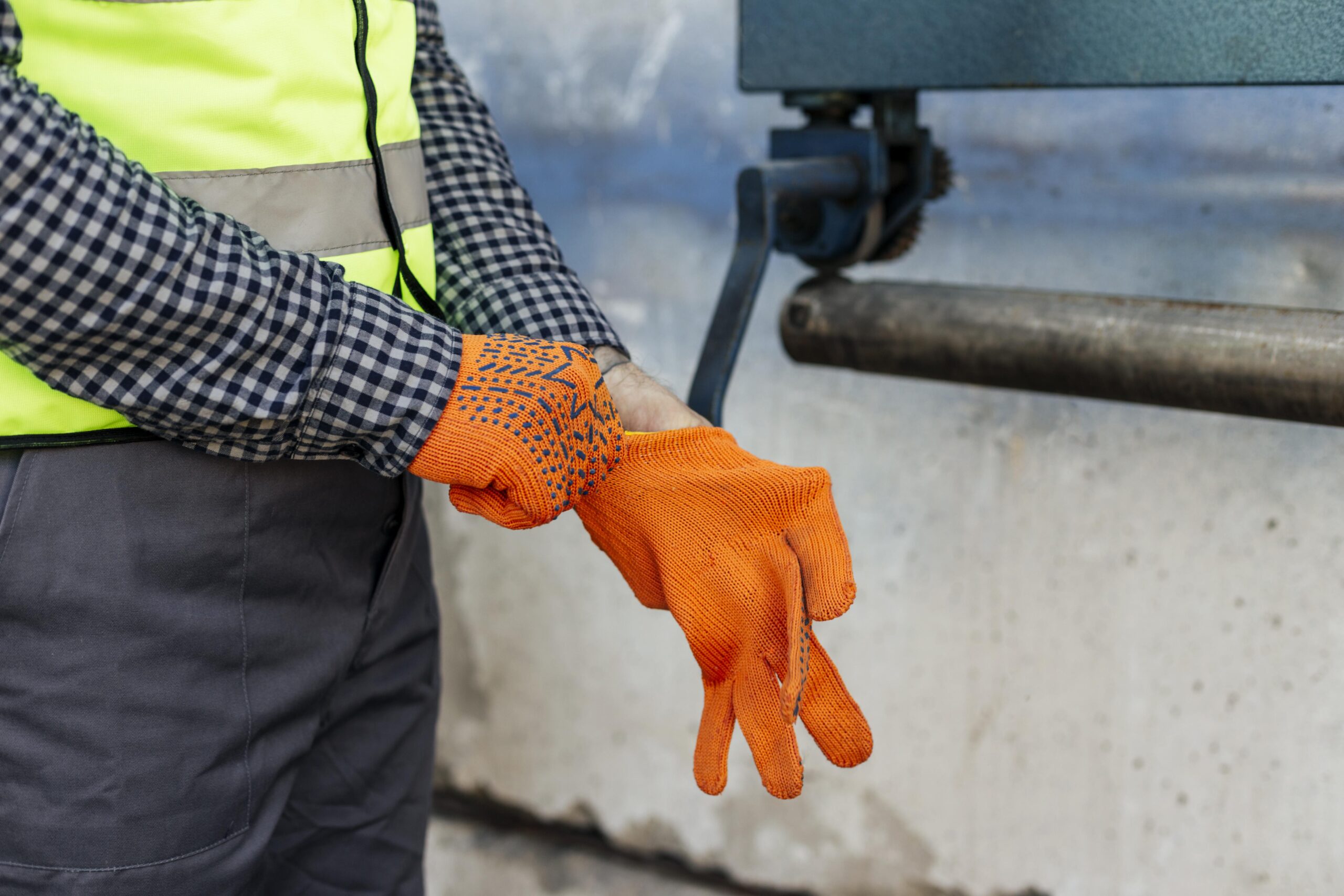 Gloved Hand Operating a Valve or Pipe During Maintenance Work